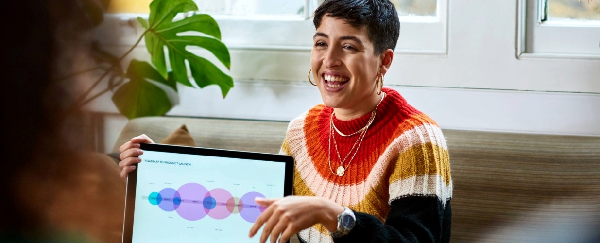 Hispanic woman holding laptop open