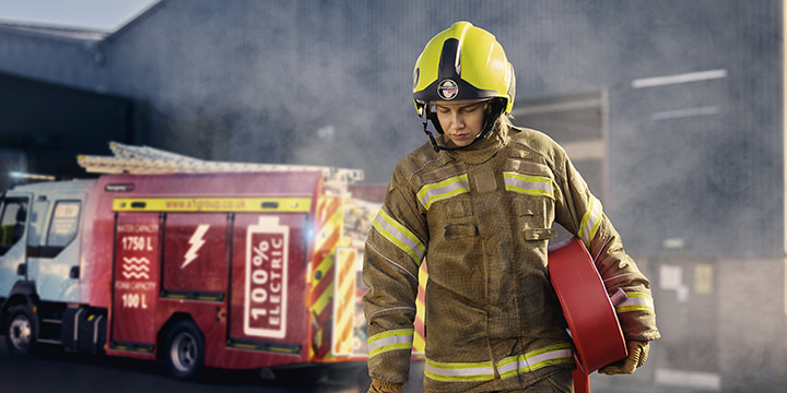 A fireman next to a fire engine