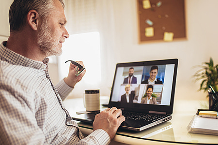 man collaborating via video meeting