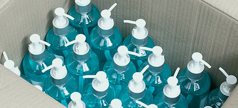 image of a box full of hand santiser bottles