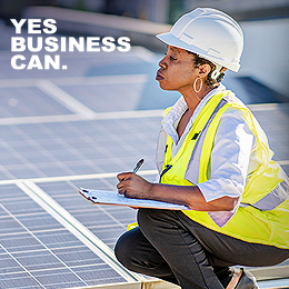 construction worker stood on solar panels