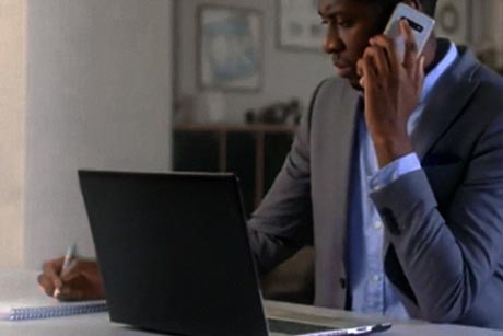 image of someone using laptop and phone