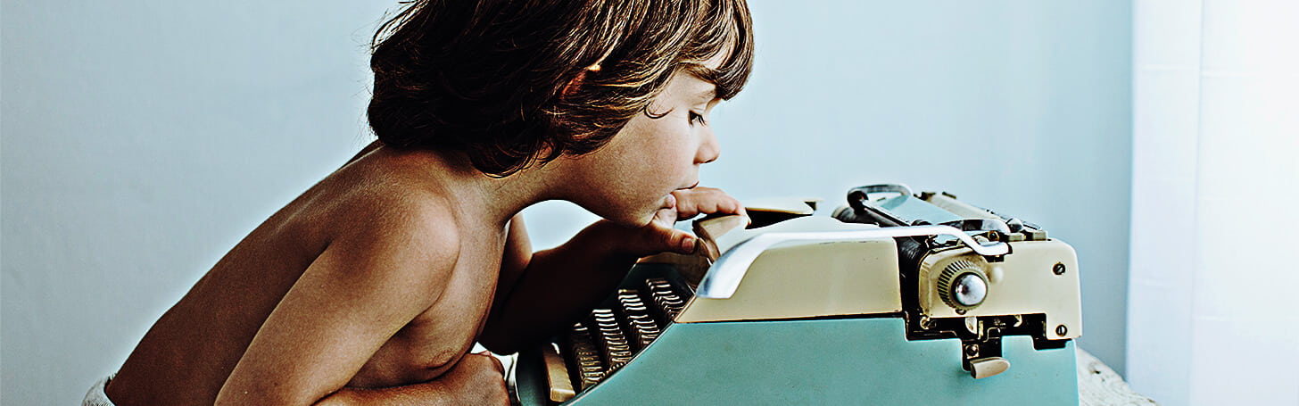 Child using typewriter
